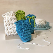 Load image into Gallery viewer, Loom knit soap sacks made on 24 peg knitting loom with video tutorial. Copyright Loomahat denise canela