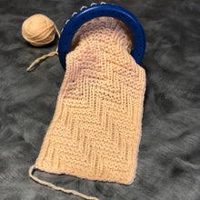 Load image into Gallery viewer, Loom Knit Chevron Zig Zag Diagonal Stitch Pattern Copyright on Yellow Red Heart Yarn using a Small Round 24-peg Knitting Loom Loomahat Copyright Image