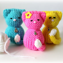 Load image into Gallery viewer, Loom Knit Tiny Kitty Cat Doll Project Pattern on a 24-peg round knitting loom . Made with Red Heart Blue Pink Yellow worsted weight scrap yarn . Copyright Loomahat

