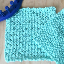 Load image into Gallery viewer, Loom KNit Seed Stitch Dishcloth pattern with video tutorial on a 24 peg loom . Copyright Loomahat