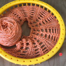 Load image into Gallery viewer, Loom Knit Little Arrowhead Stitch Shawl Pattern made with a 41 peg loom and orange worsted weight yarn. Copyright Loomahat