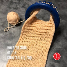 Load image into Gallery viewer, Loom Knit Chevron Zig Zag Diagonal Stitch Pattern on a blue small roung 24-peg knitting loom. Made wih Red Heart Yarn Loomahat Copyright Image