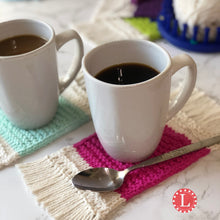 Load image into Gallery viewer, Loom Knit Mug Rug Coaster made with a round 24 peg loom and Peaches and Cream cotton yarn. Copyright Loomahat