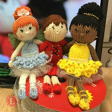 Load image into Gallery viewer, Loom knit ballerina doll project pattern.  Made on a 24 peg round knitting loom with Red Heart scrap yarn in red blue and yellow. Copyright Loomahat