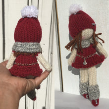 Load image into Gallery viewer, Loom Knit Doll Project Pattern. Made on a 24 peg round loom with Red Heart burgundy worsted weight and Paton scrap yarn. Copyright Loomahat
