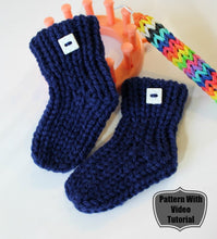 Load image into Gallery viewer, Loom knit baby booties socks pattern. Made with Red Heart blue worsted weight yarn on 24 peg loom. Copyright Loomahat 

